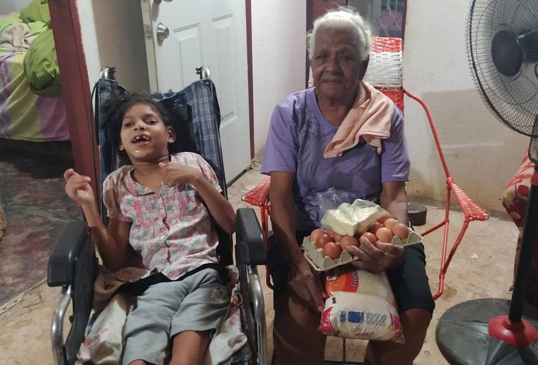 Emotional core - elderly woman and child with genuine joy receiving food